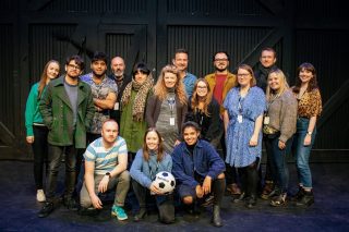 Theatre group standing on stage.