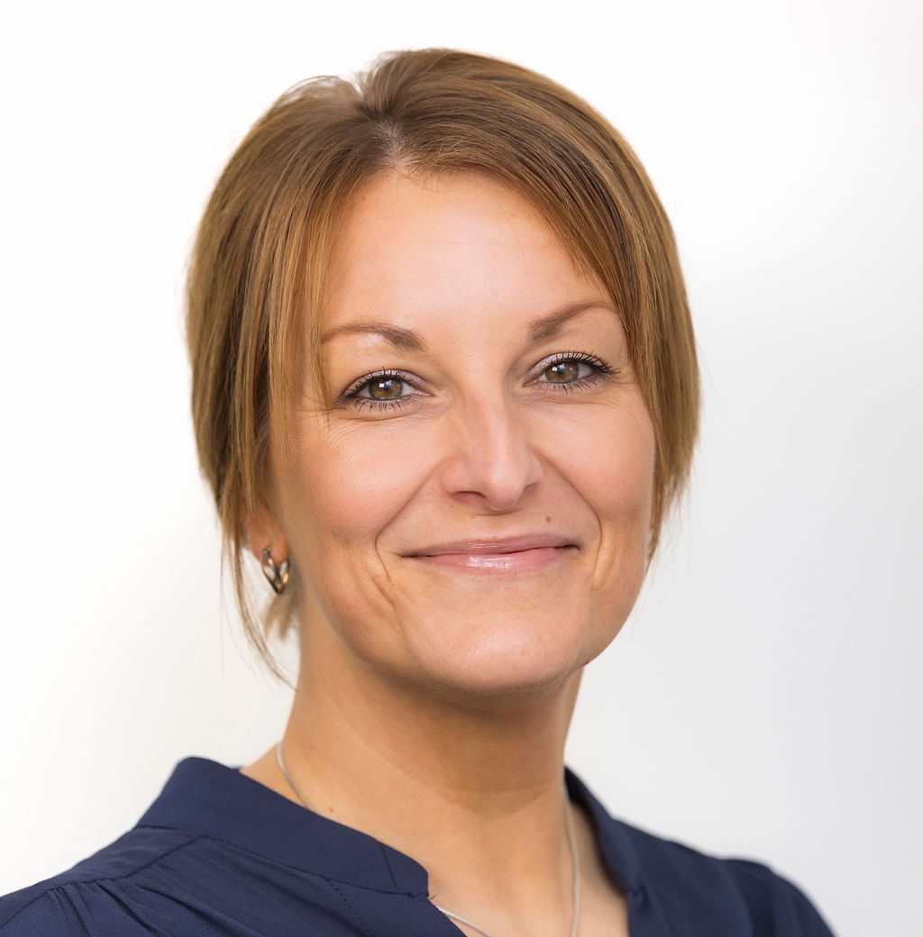 An image of Rachel Coupland wearing a blue shirt and smiling at the camera.