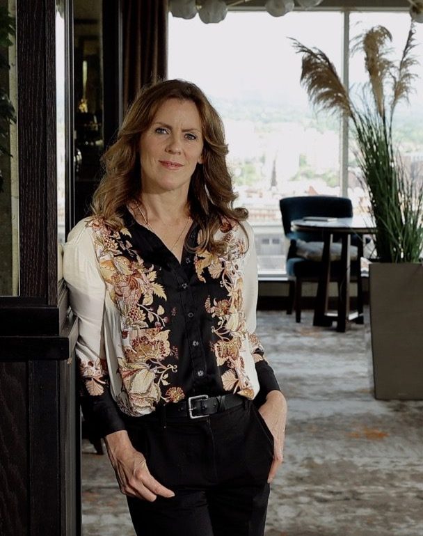 Emer Hinphey, Partner at AAB People standing in office.