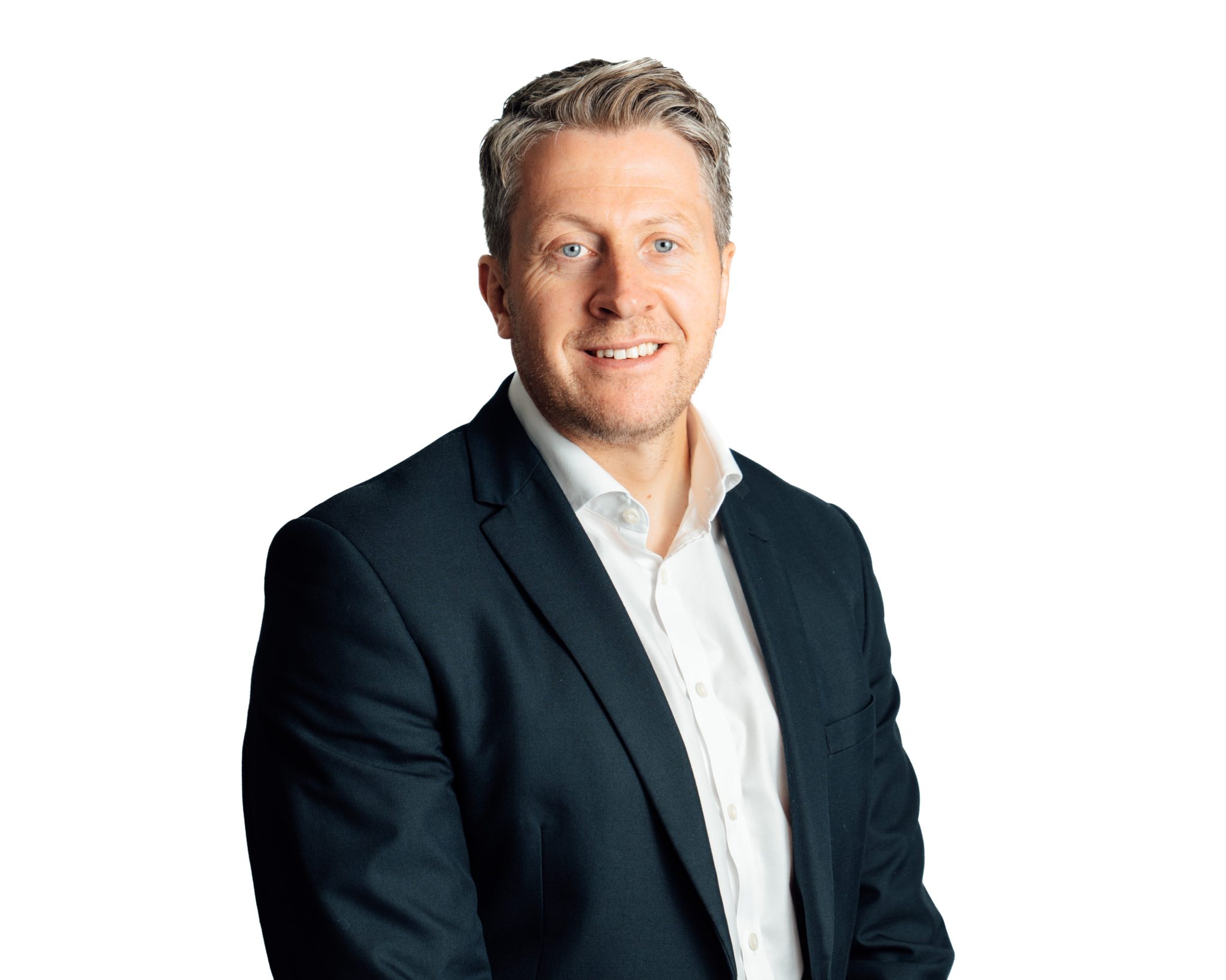 An image of Paul Turner wearing a suit and smiling at the camera.