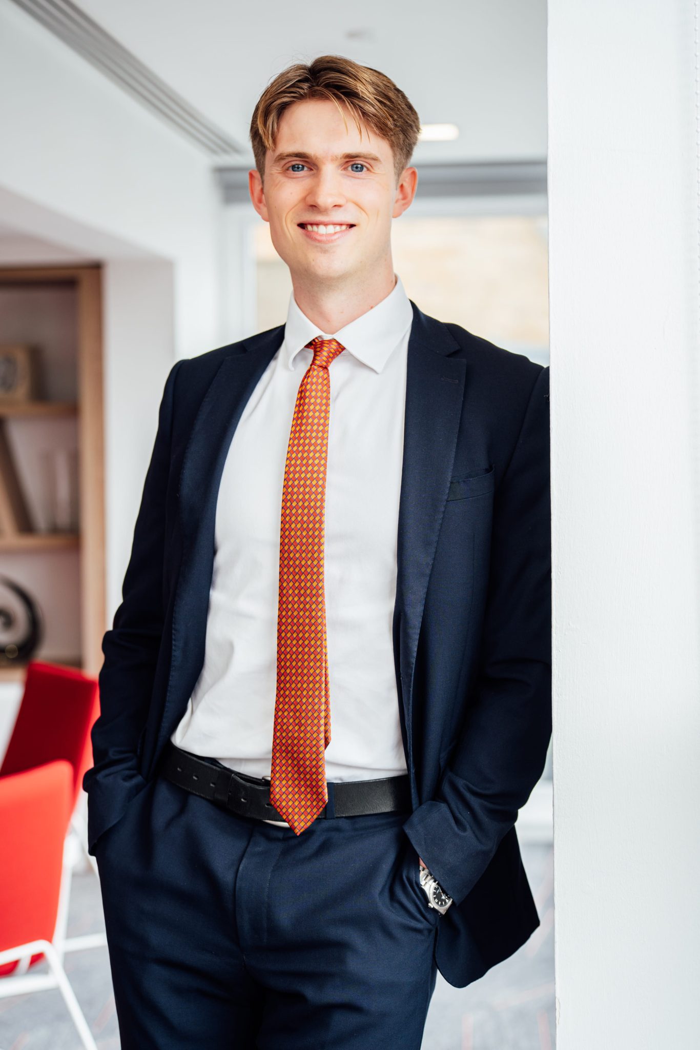 An image of Thomas Hill standing in the office and smiling at the camera.