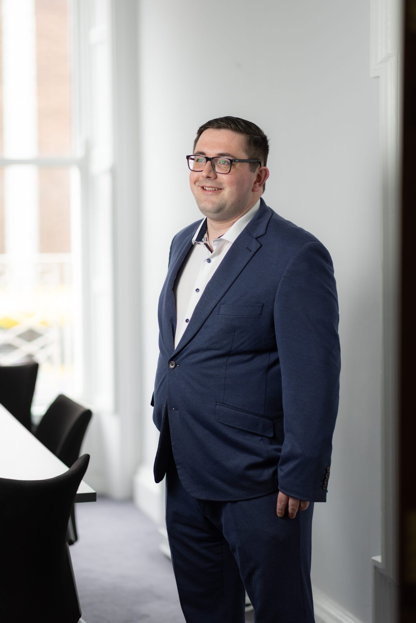 An image of Thomas Byrne standing in the office wearing a suit.